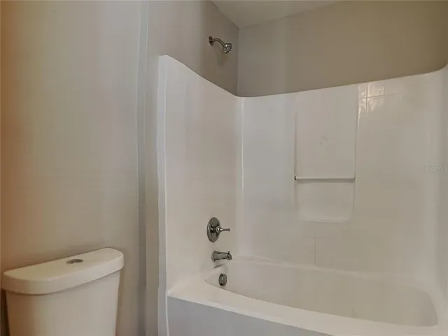 a bathroom with a bathtub and a toilet
