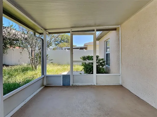 a view of an empty room and a window