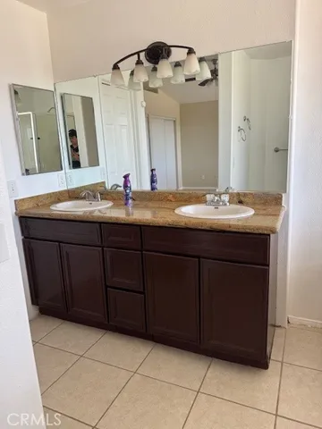 a bathroom with a double vanity sink and a mirror