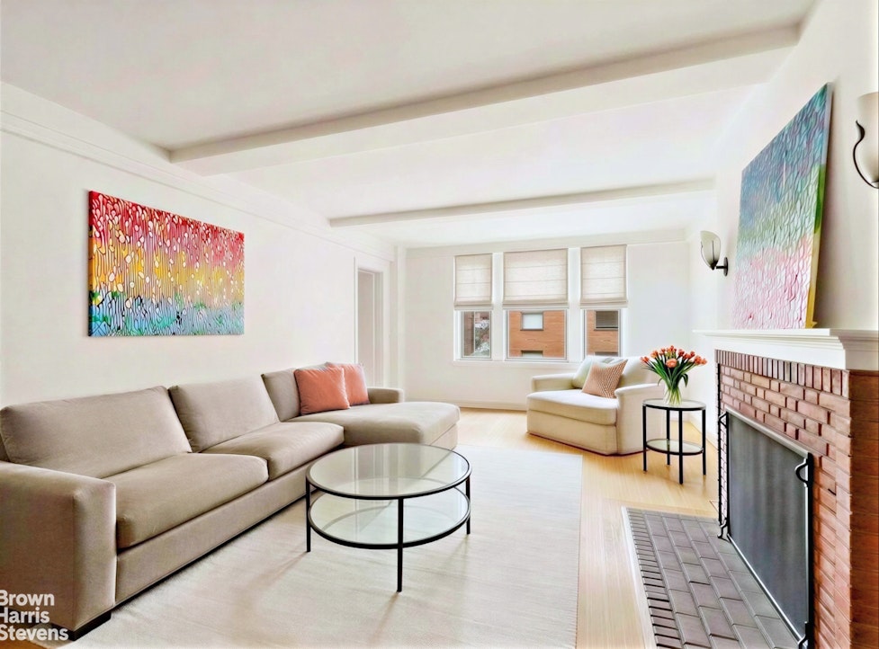 220 East 73rd Street, Unit 9H Manhattan, NY 10021 - Photo 3 of 15 a living room with furniture and a fireplace