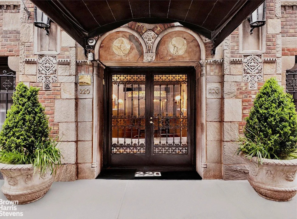 220 East 73rd Street, Unit 9H Manhattan, NY 10021 - Photo 9 of 15 a front view of a house with potted plants