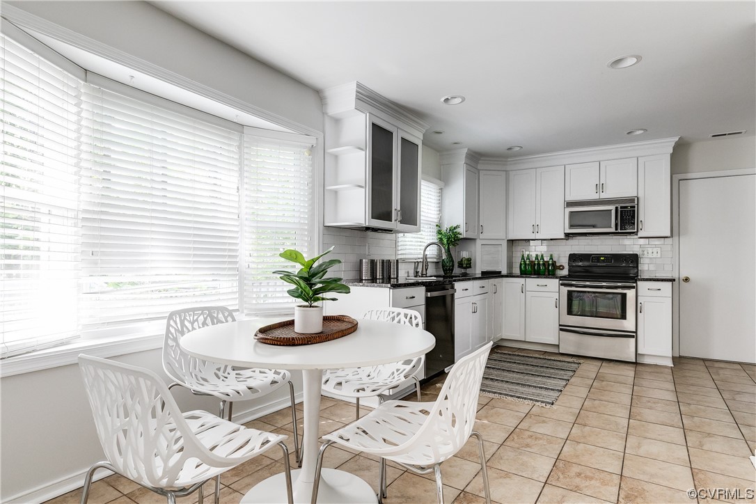 6007 Mill Spring Court Midlothian, VA 23112 - Photo 14 of 37 a kitchen with stainless steel appliances kitchen island granite countertop a refrigerator a stove a sink dishwasher and white cabinets with wooden floor