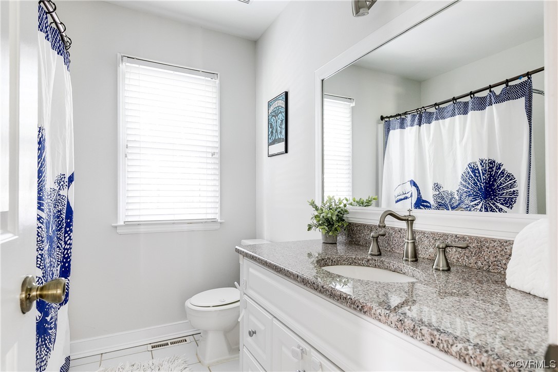 6007 Mill Spring Court Midlothian, VA 23112 - Photo 25 of 37 a bath room with a granite countertop toilet a sink and a tub