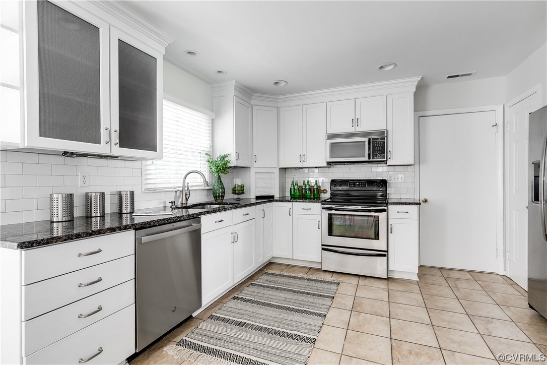 6007 Mill Spring Court Midlothian, VA 23112 - Photo 9 of 37 a kitchen with granite countertop a sink a stove and cabinets