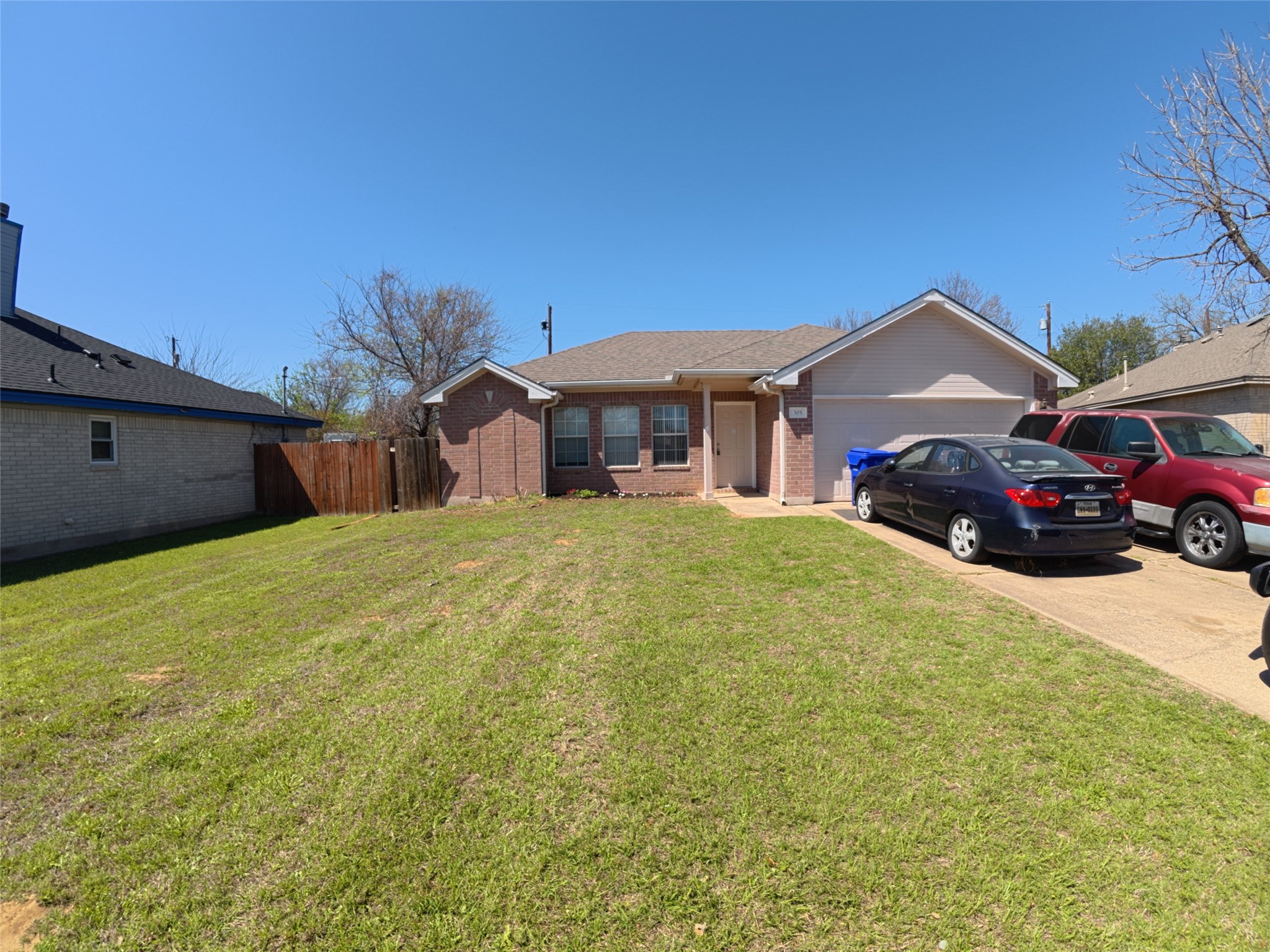 305 China Cove Elgin, TX 78621 - Photo 3 of 19 a front view of a house with a yard and garage