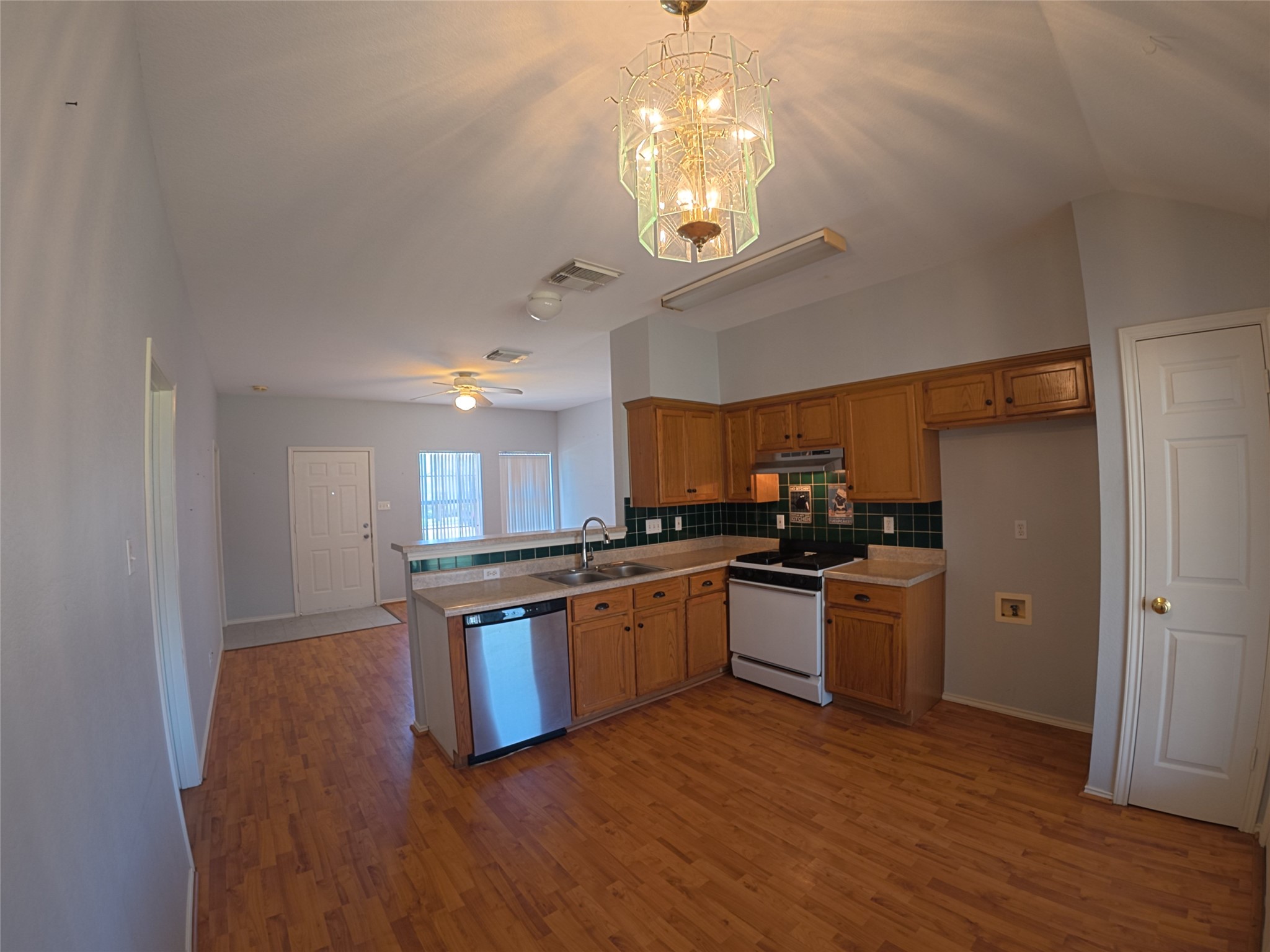 305 China Cove Elgin, TX 78621 - Photo 4 of 19 a kitchen with stainless steel appliances granite countertop a stove and a refrigerator