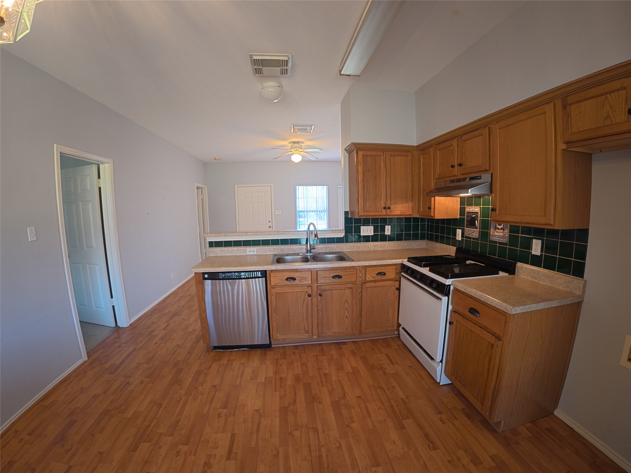 305 China Cove Elgin, TX 78621 - Photo 5 of 19 a kitchen with granite countertop a sink cabinets and wooden floor