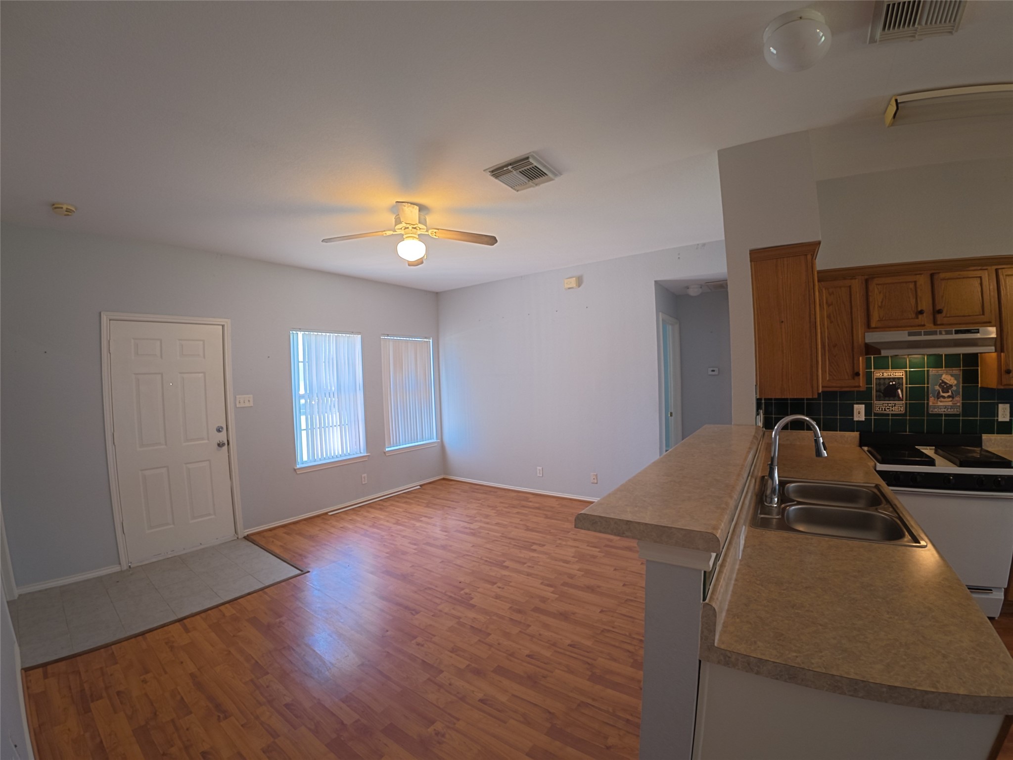 305 China Cove Elgin, TX 78621 - Photo 6 of 19 a view of a kitchen with a sink dishwasher and a fireplace