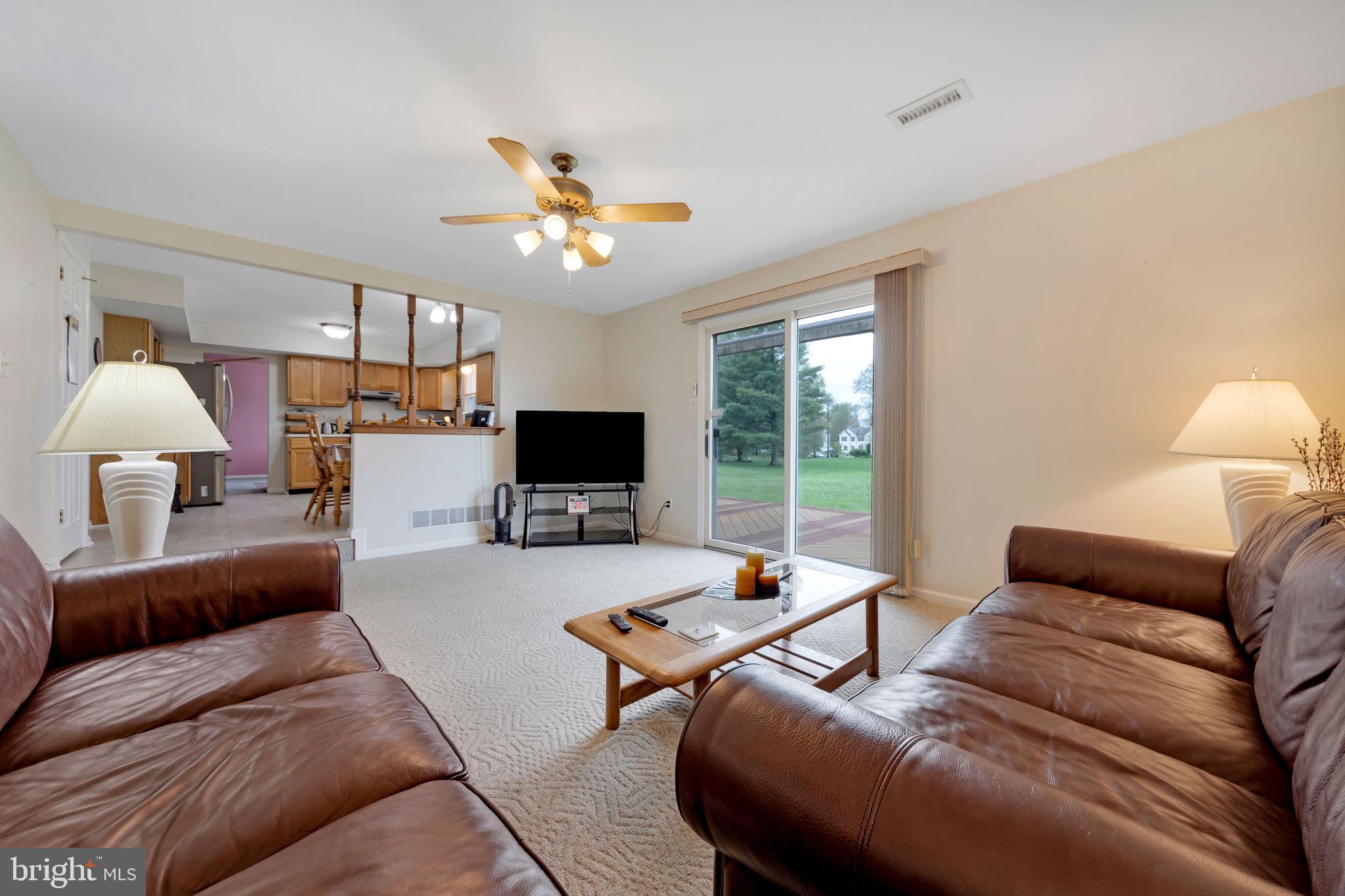 1072 Independence Way Hatfield, PA 19440 - Photo 19 of 37 a living room with furniture a chandelier and a flat screen tv