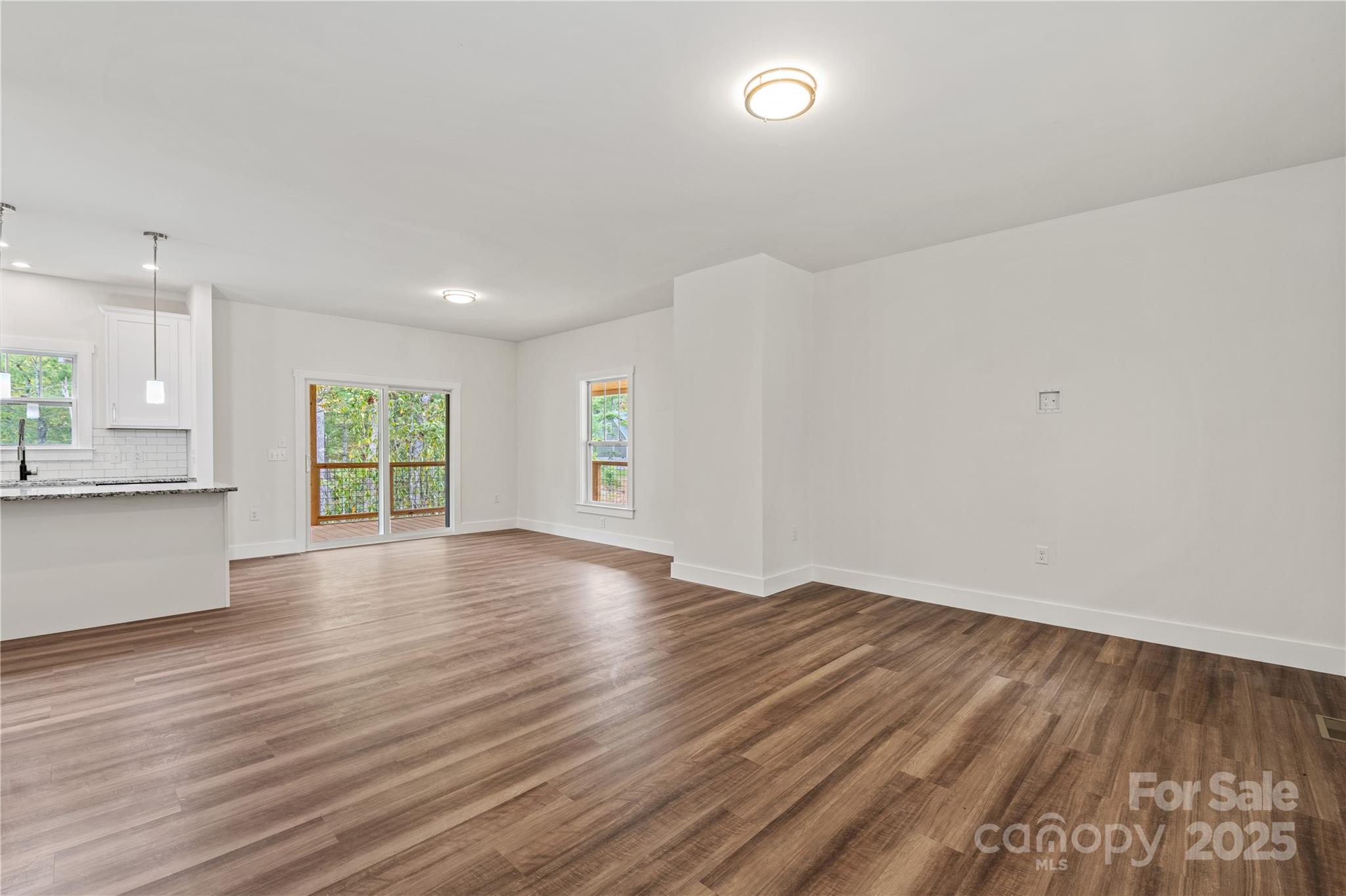 206 Cascade Rdg Road Fairview, NC 28730 - Photo 16 of 38 an empty room with wooden floor and windows