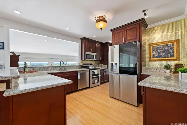 a kitchen with stainless steel appliances granite countertop a sink dishwasher stove and refrigerator