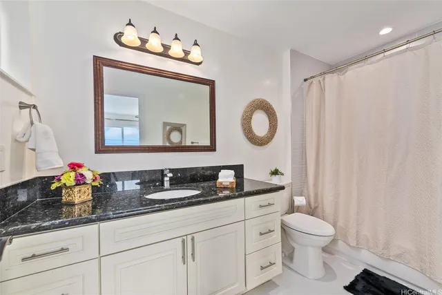 a bathroom with a toilet a sink and a mirror