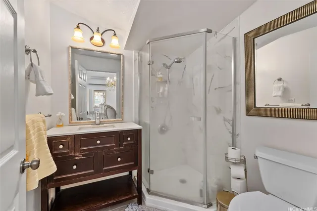 a bathroom with a toilet a sink and a mirror