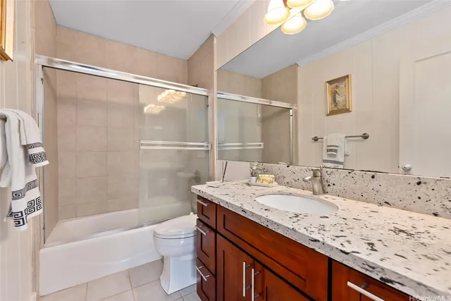 a bathroom with a granite countertop sink mirror toilet and bathtub