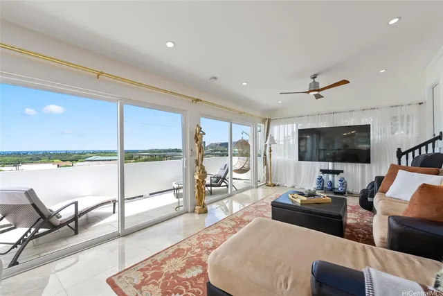 a living room with furniture and a floor to ceiling window