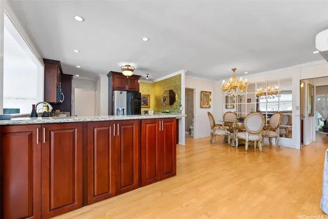 a living room with furniture a chandelier and a dining table