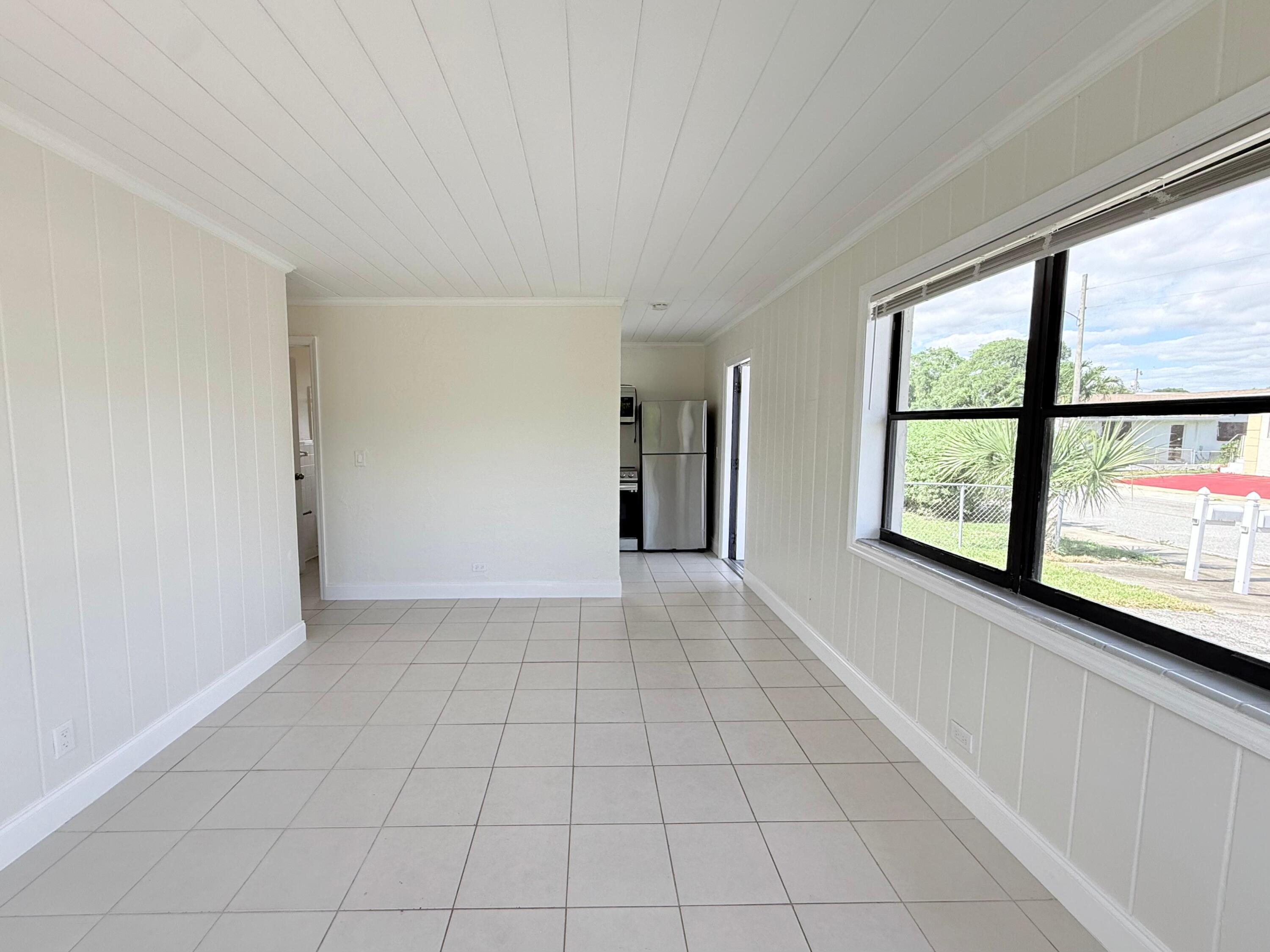 1409 West 33rd Street, Unit 1 Riviera Beach, FL 33404 - Photo 3 of 13 an empty room with windows