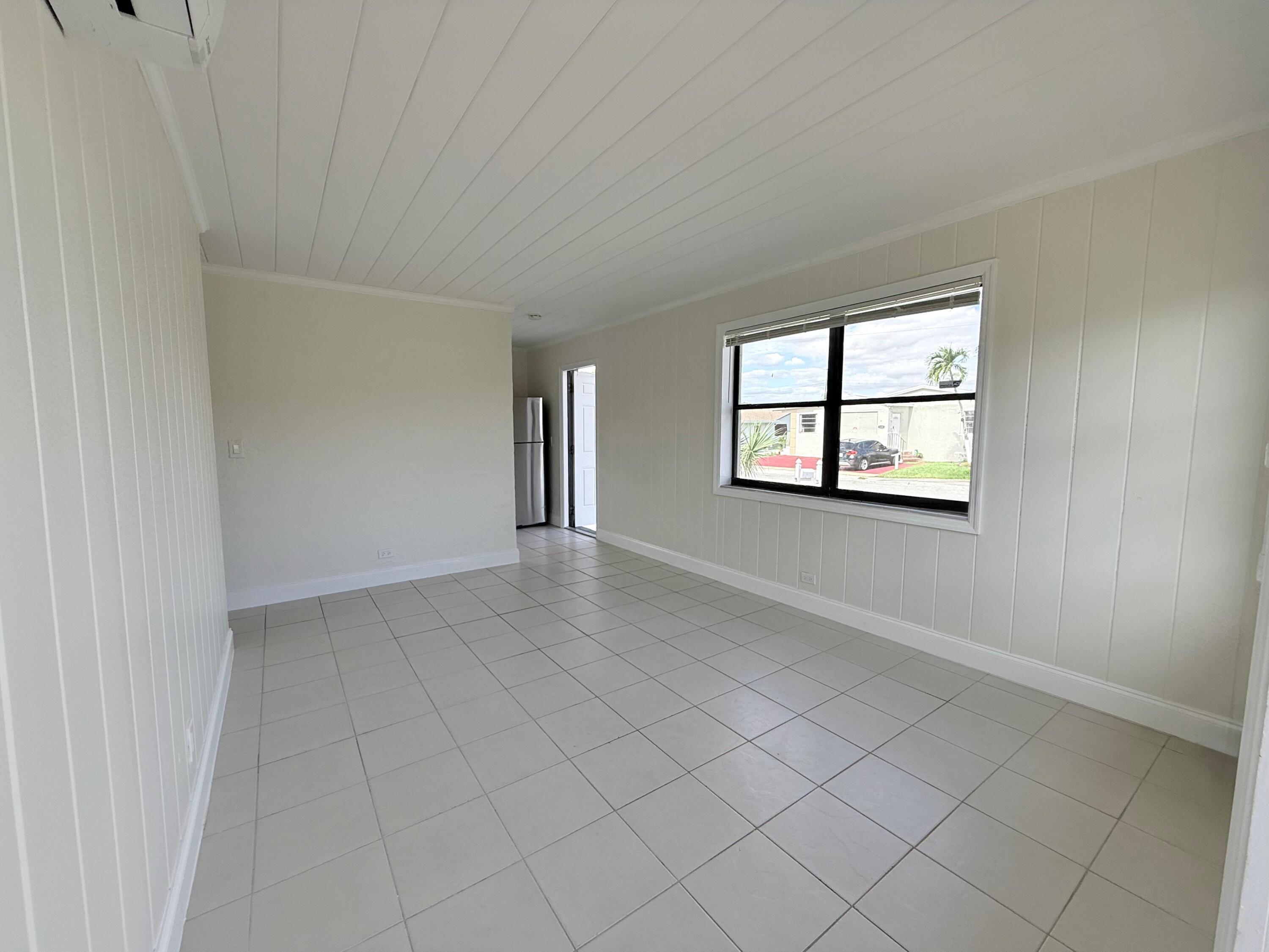 1409 West 33rd Street, Unit 1 Riviera Beach, FL 33404 - Photo 7 of 13 an empty room with windows