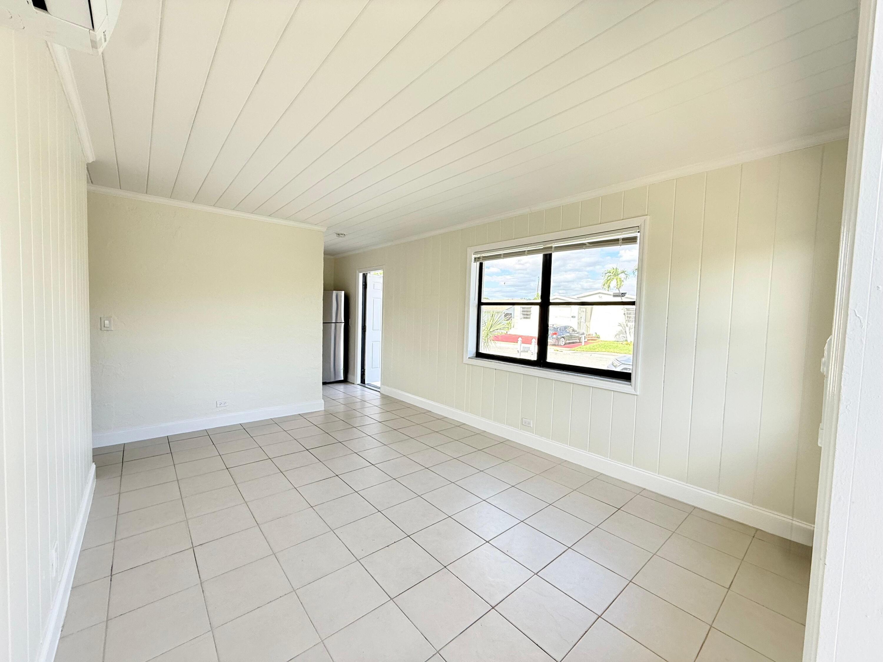 1409 West 33rd Street, Unit 1 Riviera Beach, FL 33404 - Photo 8 of 13 an empty room with windows