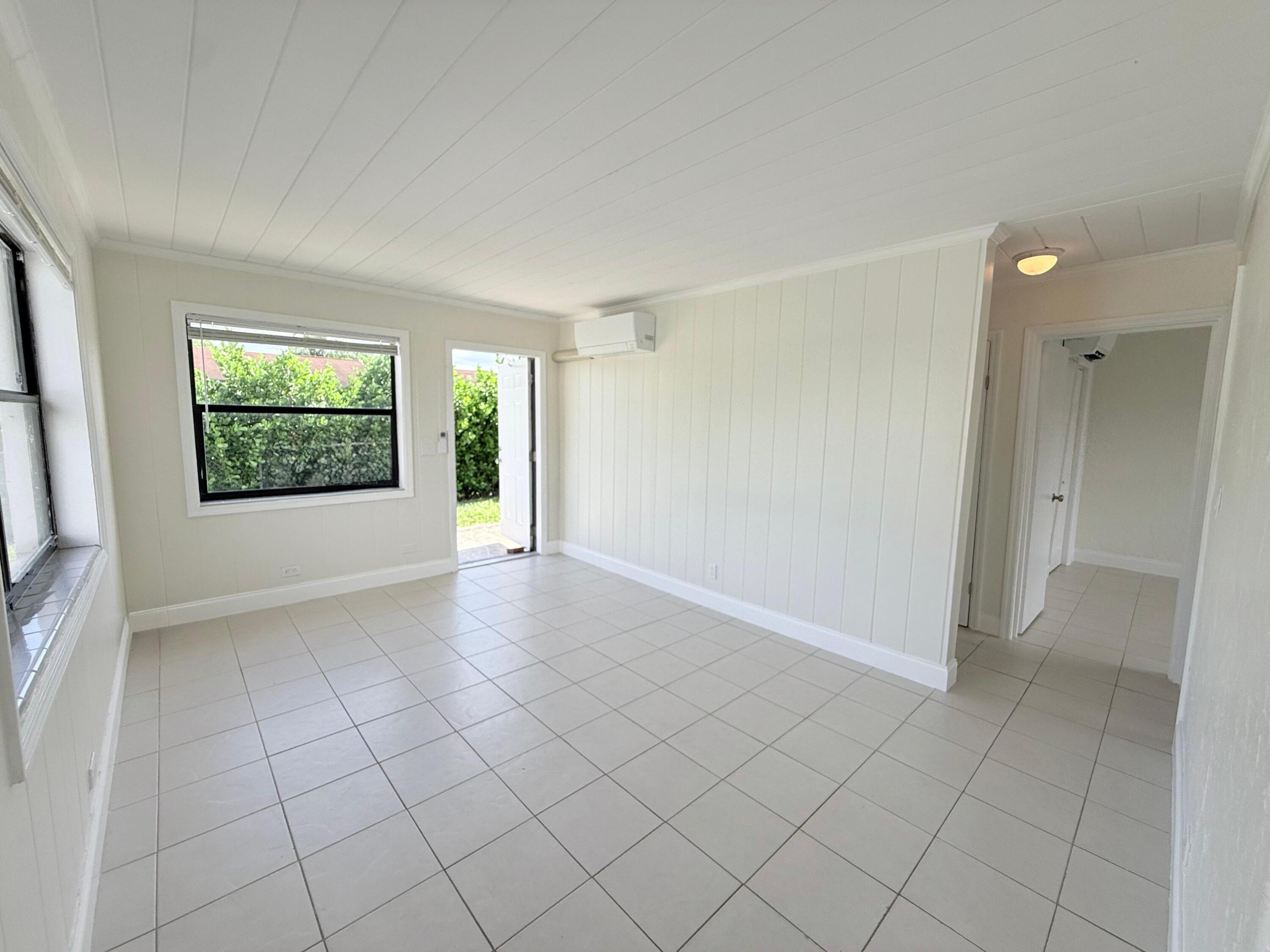 1409 West 33rd Street, Unit 1 Riviera Beach, FL 33404 - Photo 10 of 13 an empty room with windows