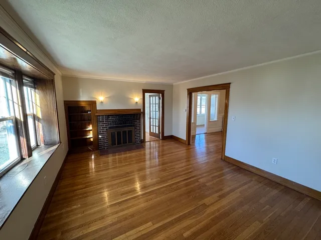 wooden floor in an empty room with a fireplace