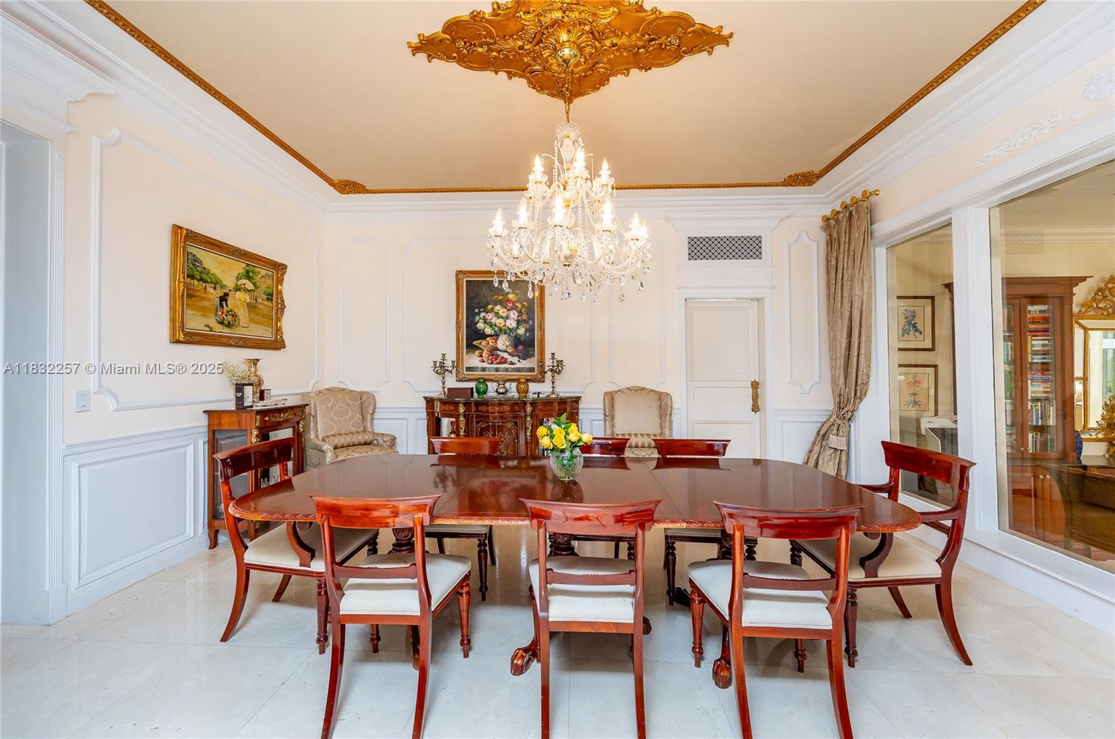4539 Pine Tree Drive Miami Beach, FL 33140 - Photo 11 of 17 a view of a dining room with furniture and chandelier