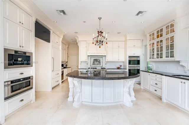 a kitchen with stainless steel appliances kitchen island granite countertop a sink and cabinets