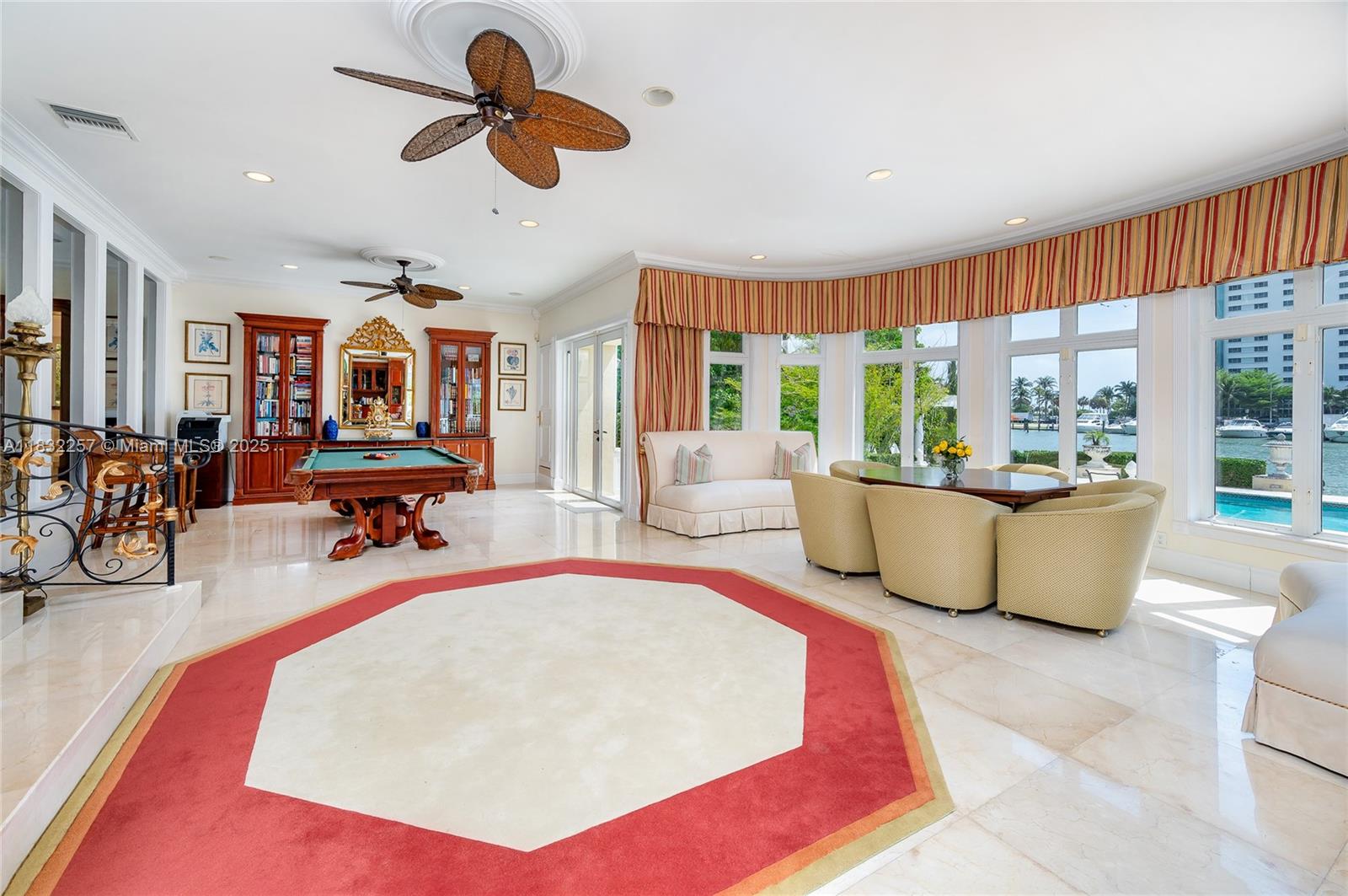 4539 Pine Tree Drive Miami Beach, FL 33140 - Photo 14 of 17 a very nice looking room with kitchen view and a fireplace