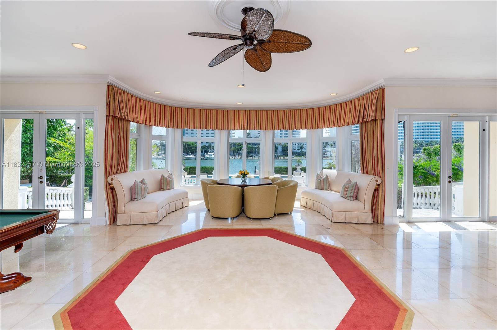 4539 Pine Tree Drive Miami Beach, FL 33140 - Photo 15 of 17 a living room with furniture and a large window