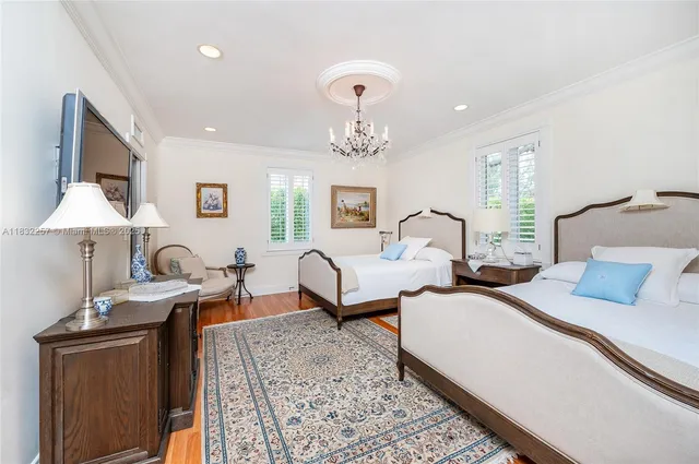 a bedroom with two beds and a dresser