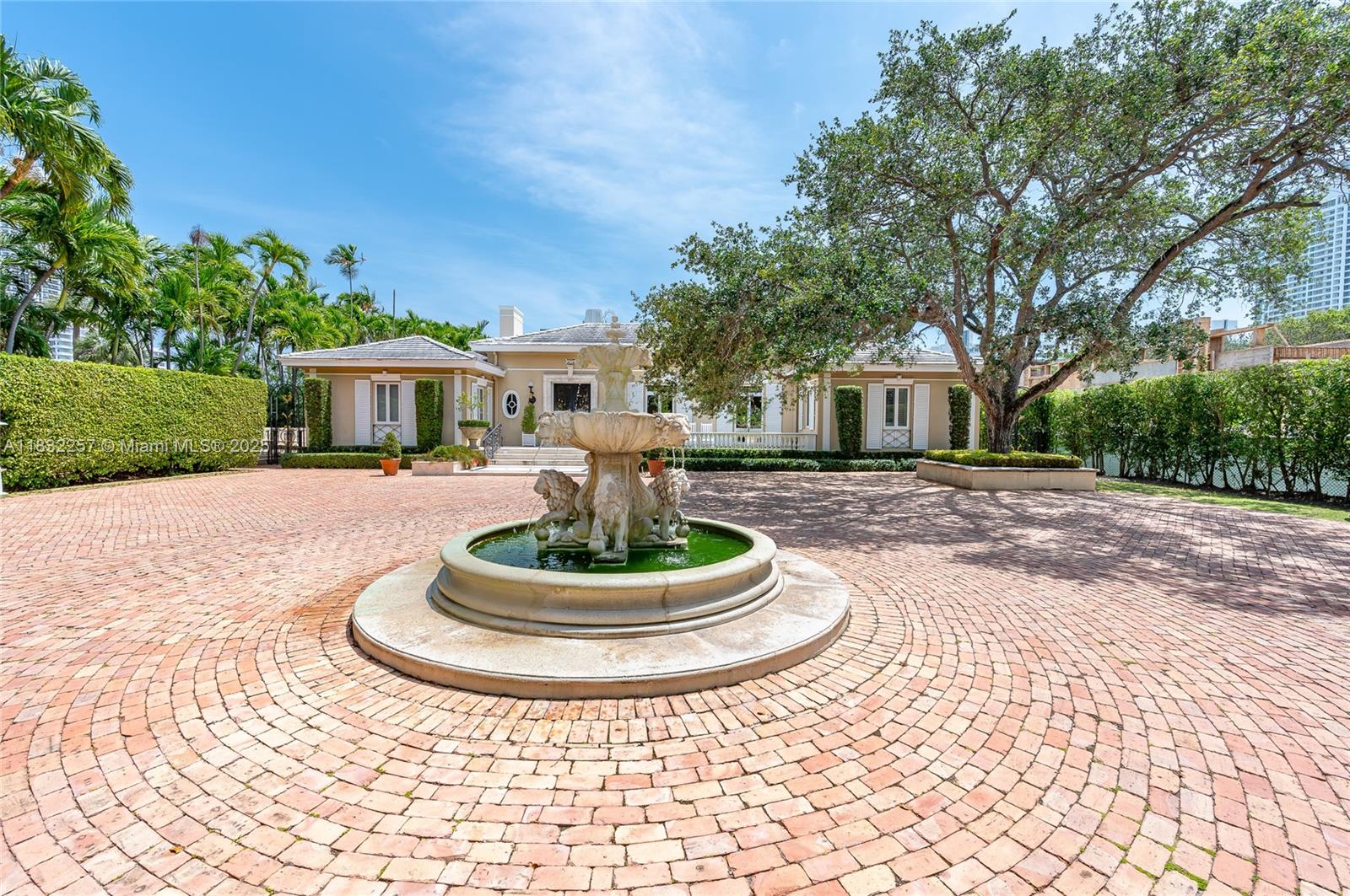 4539 Pine Tree Drive Miami Beach, FL 33140 - Photo 3 of 17 a front view of a house with a yard table and chairs