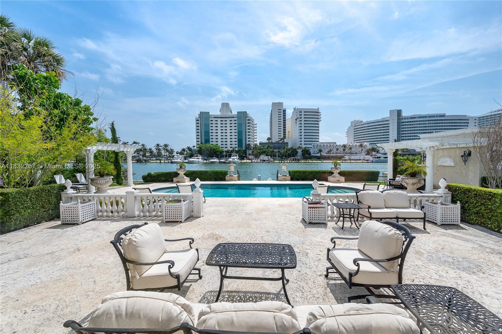 4539 Pine Tree Drive Miami Beach, FL 33140 - Photo 5 of 17 a view of a roof deck with couches and potted plants