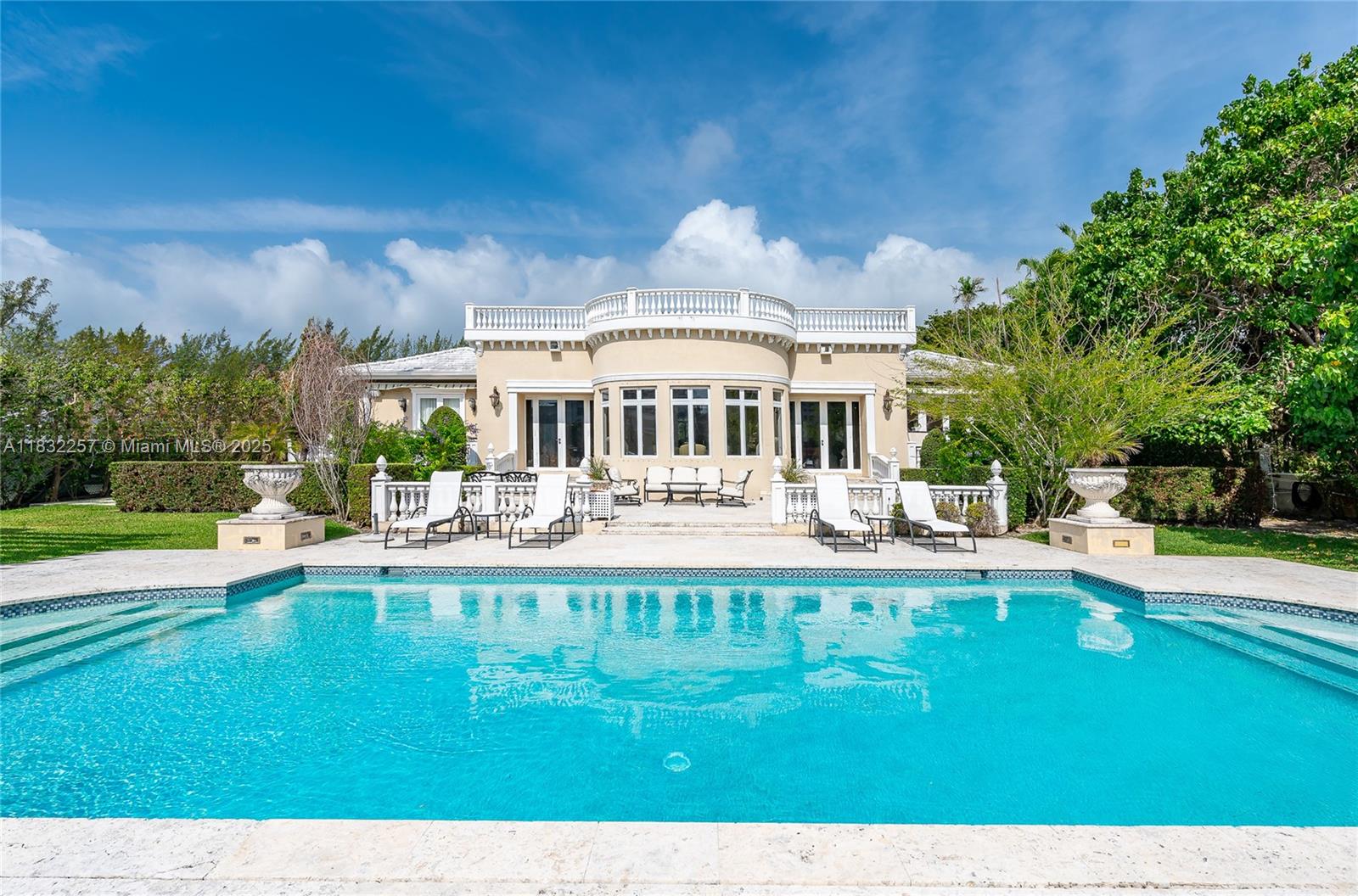 4539 Pine Tree Drive Miami Beach, FL 33140 - Photo 7 of 17 a view of a house with swimming pool and a yard
