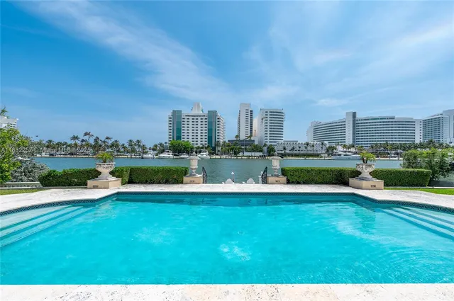 a view of a house with swimming pool and a yard