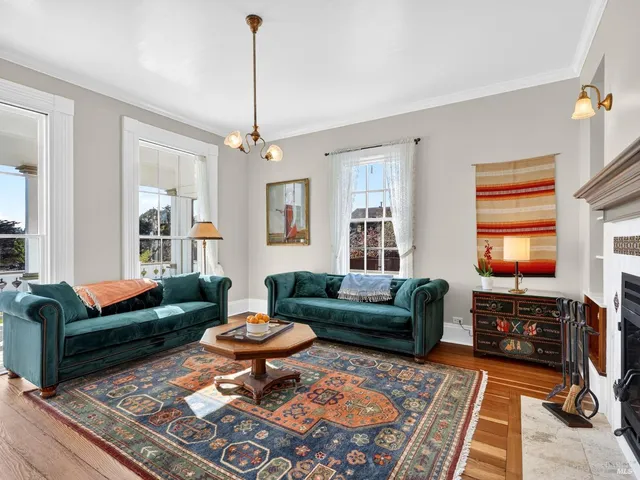 a living room with furniture a rug and a window