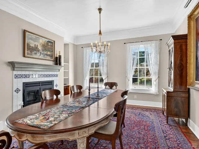 a dining room with furniture window and wooden floor