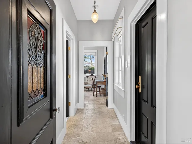a view of a hallway with wooden shelves