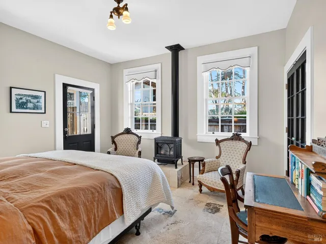 a bedroom with a bed a dresser and a flat screen tv