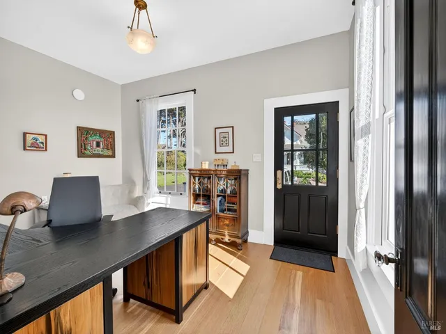 a view of a workspace with furniture and a window