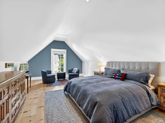 a spacious bedroom with a bed a couch and dresser