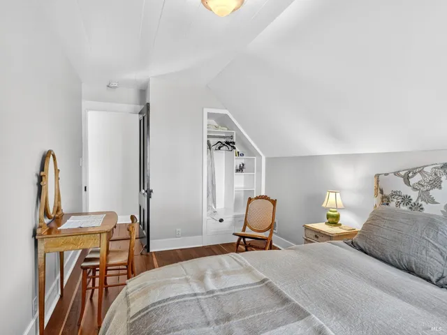 a view of a room with wooden floor and windows