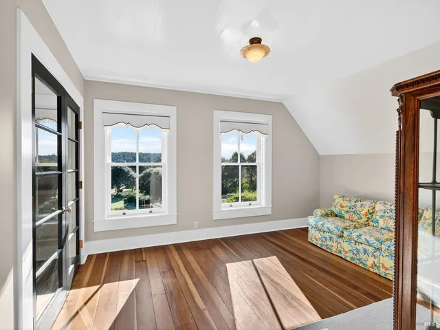 a bathroom with a granite countertop sink a toilet a mirror and shower