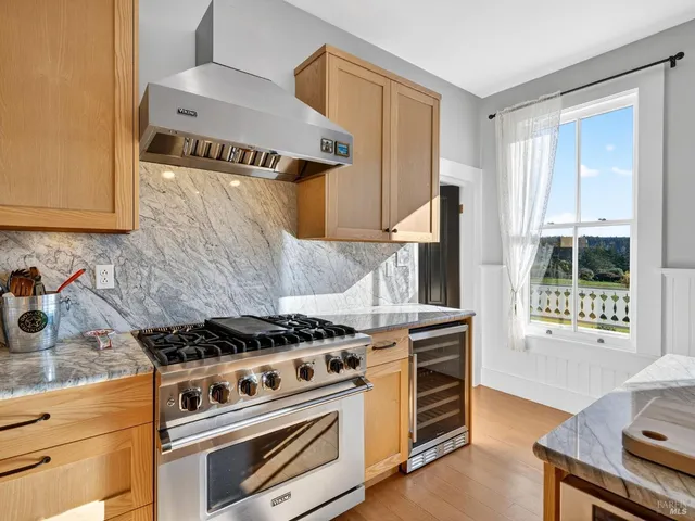 a kitchen with granite countertop a stove and a sink