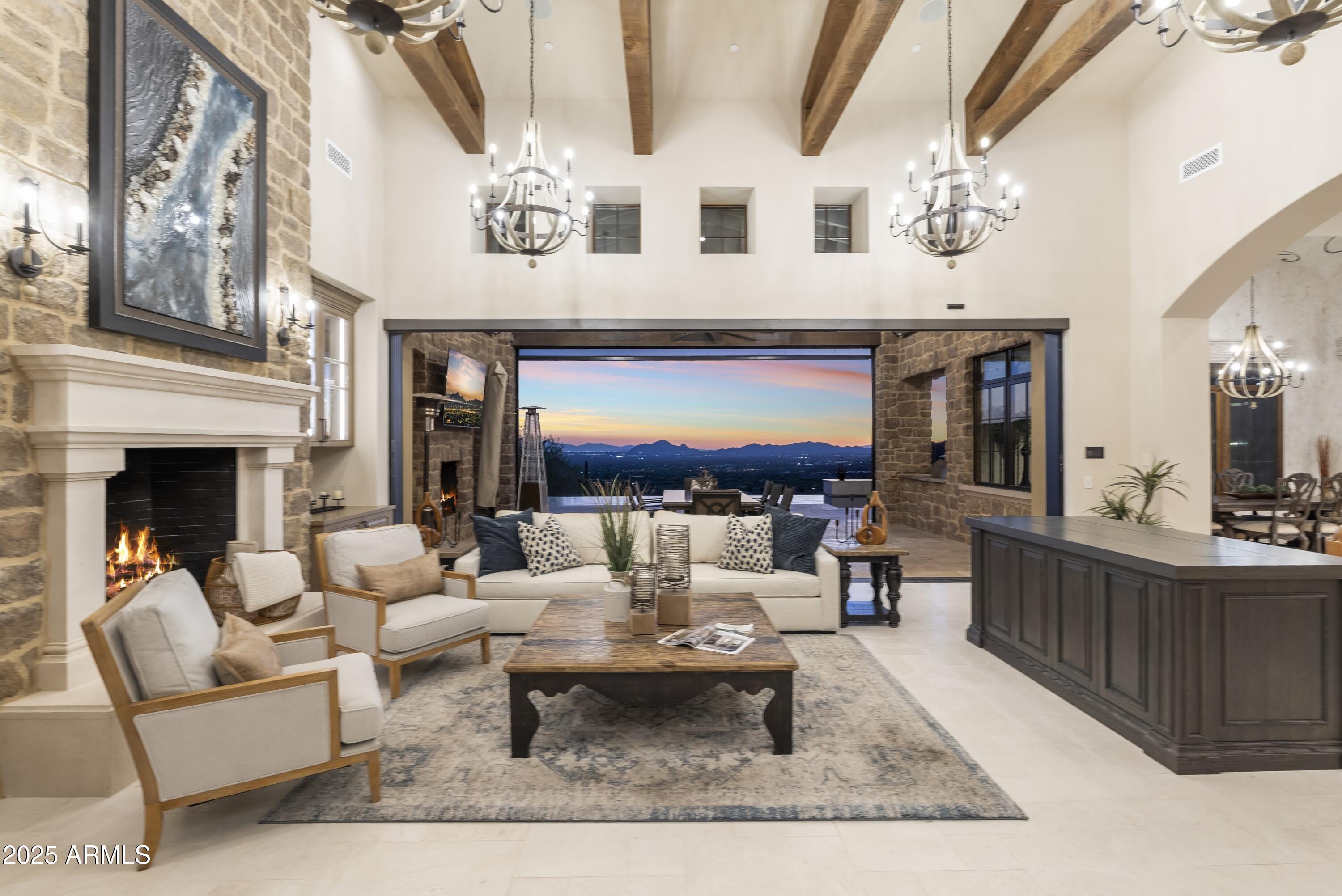 14699 East Paradise Drive, Unit 26 Scottsdale, AZ 85259 - Photo 29 of 73 a living room with furniture a chandelier and a fireplace