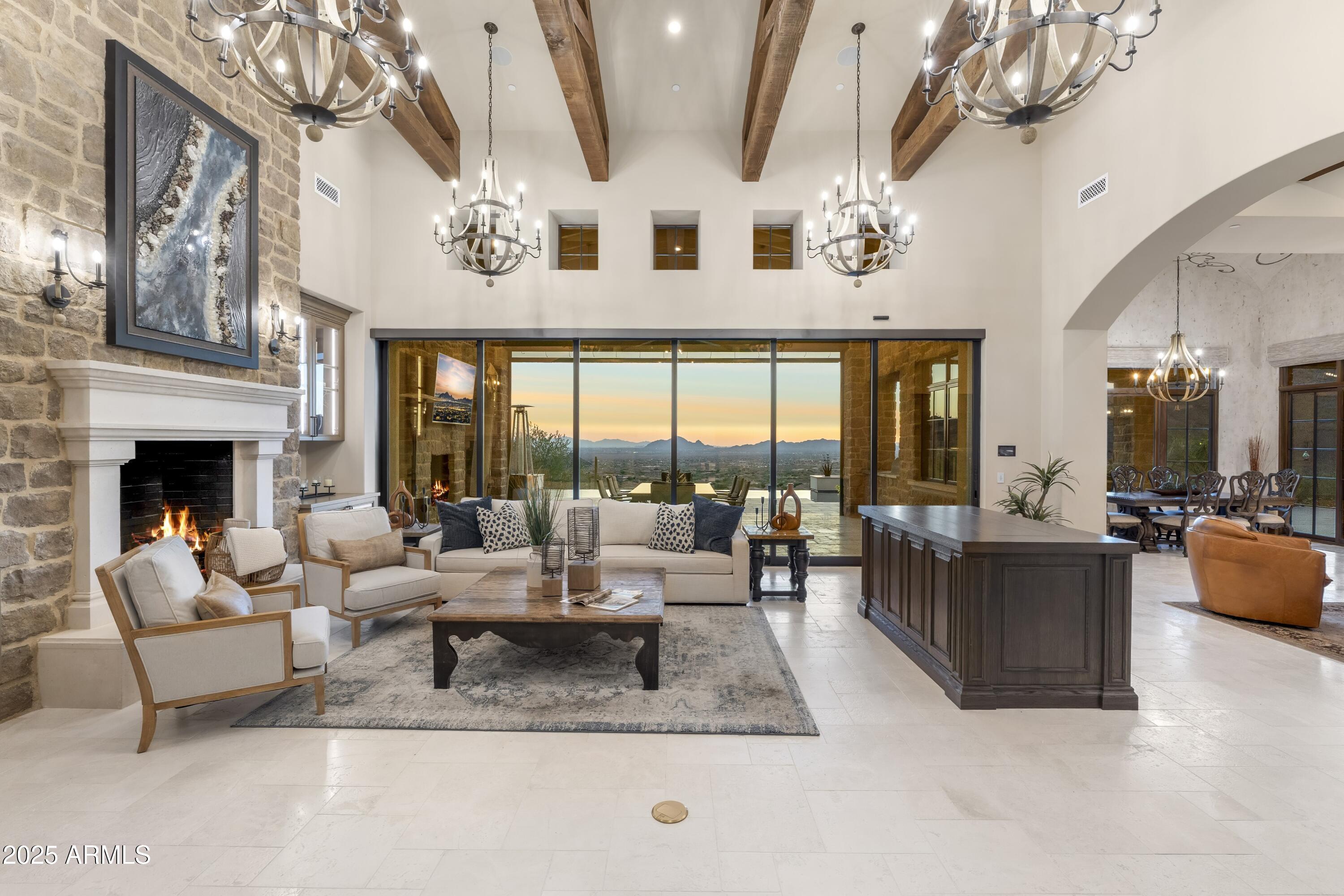 14699 East Paradise Drive, Unit 26 Scottsdale, AZ 85259 - Photo 30 of 73 a living room with furniture large windows and a fireplace