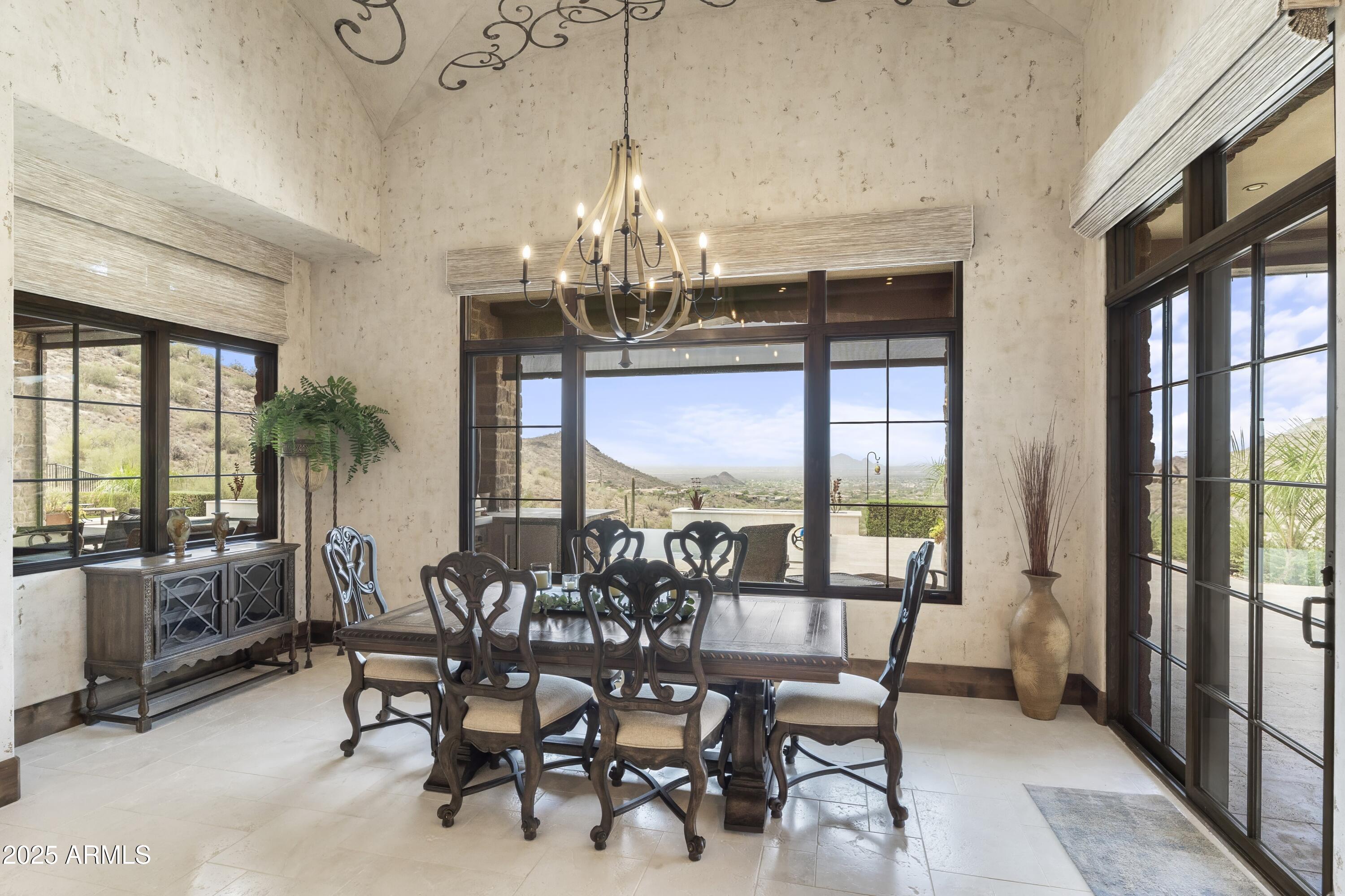 14699 East Paradise Drive, Unit 26 Scottsdale, AZ 85259 - Photo 38 of 73 a view of a dining room with furniture a chandelier and large windows
