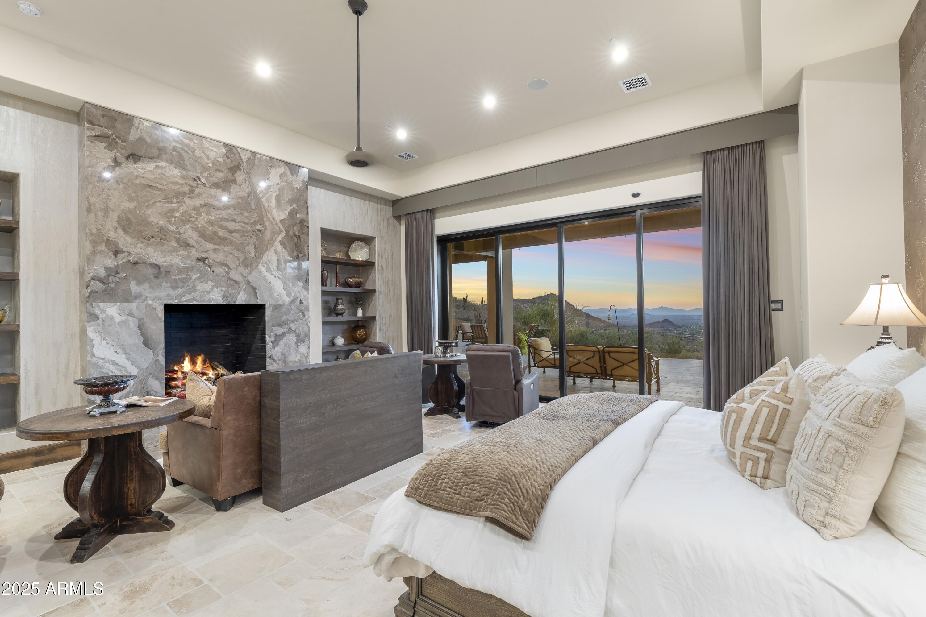 14699 East Paradise Drive, Unit 26 Scottsdale, AZ 85259 - Photo 50 of 73 a spacious bedroom with a balcony a bed and a fireplace