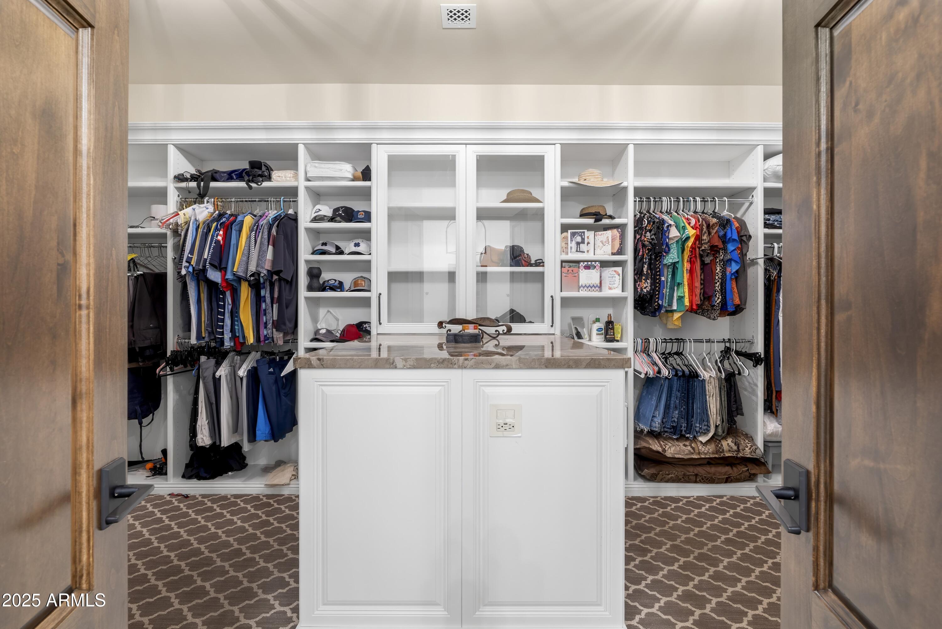14699 East Paradise Drive, Unit 26 Scottsdale, AZ 85259 - Photo 62 of 73 a view of walk in closet with clothes and shoes