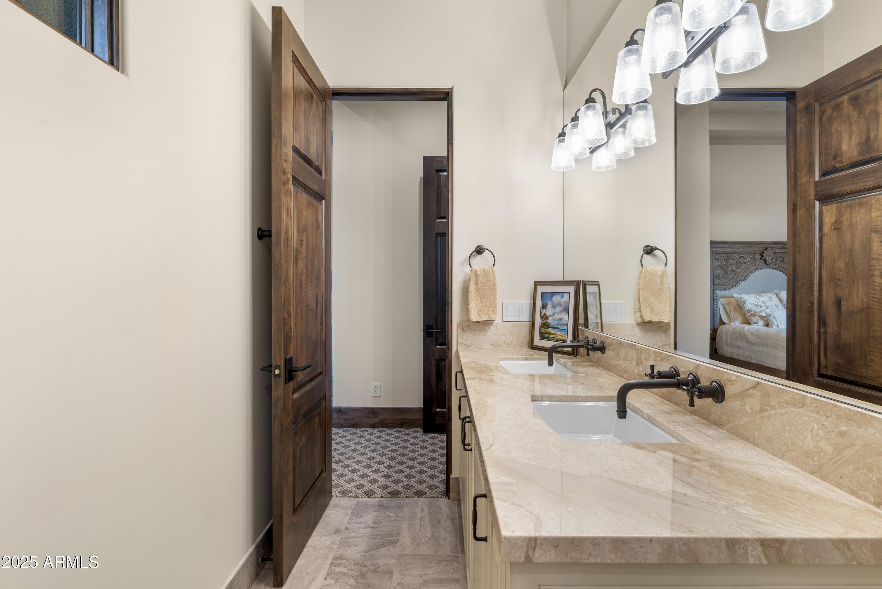 14699 East Paradise Drive, Unit 26 Scottsdale, AZ 85259 - Photo 65 of 73 a bathroom with a granite countertop sink and a mirror
