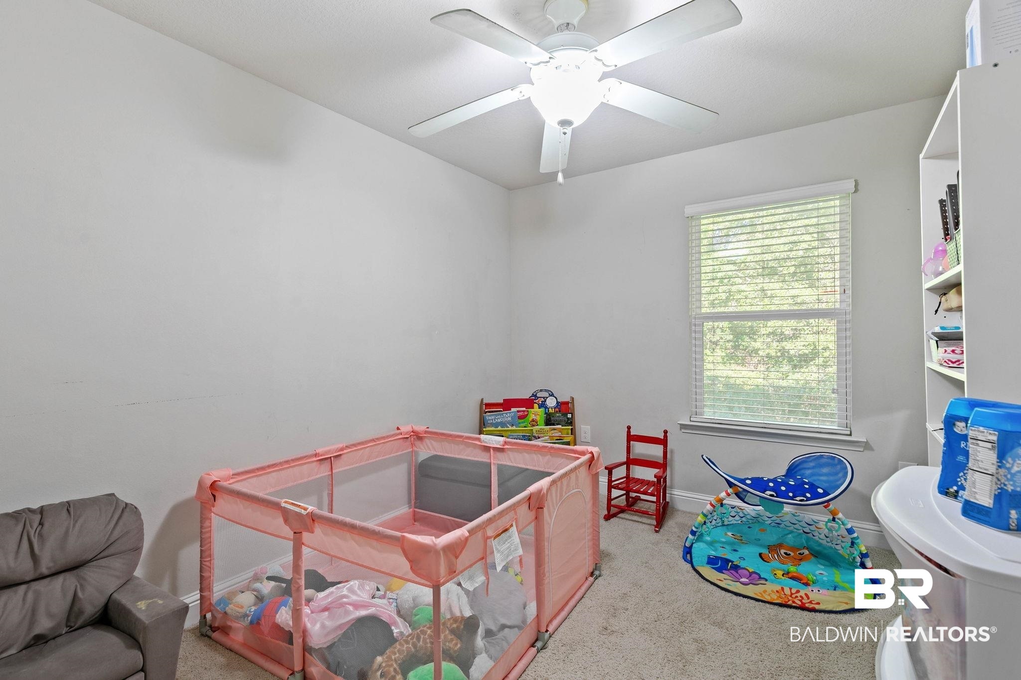 25806 Pollard Road, Unit 24 Daphne, AL 36526 - Photo 21 of 33 Playroom with light colored carpet and baseboards
